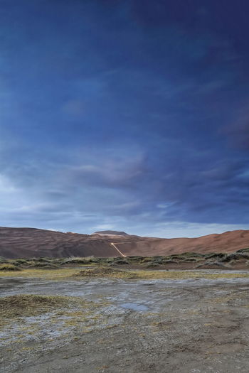 1121 sumu jaran lakebed among badain jaran desert megadunes-sunset leaden sky -inner mongolia-china.