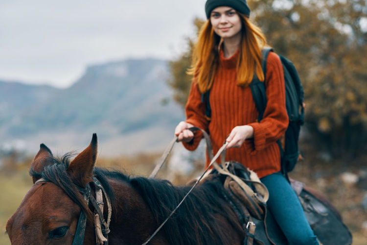 Young woman riding horse
