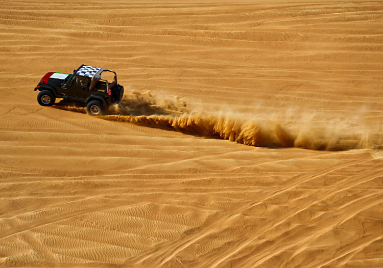 Tire tracks on sand dune in desert