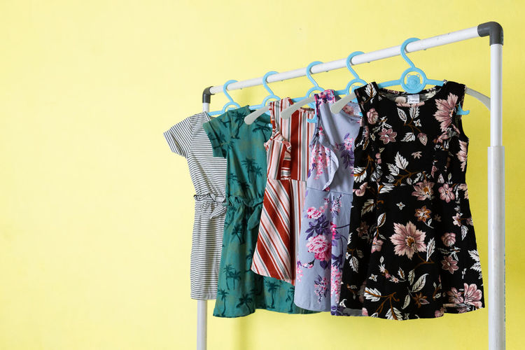 Clothes hanging on rack against wall