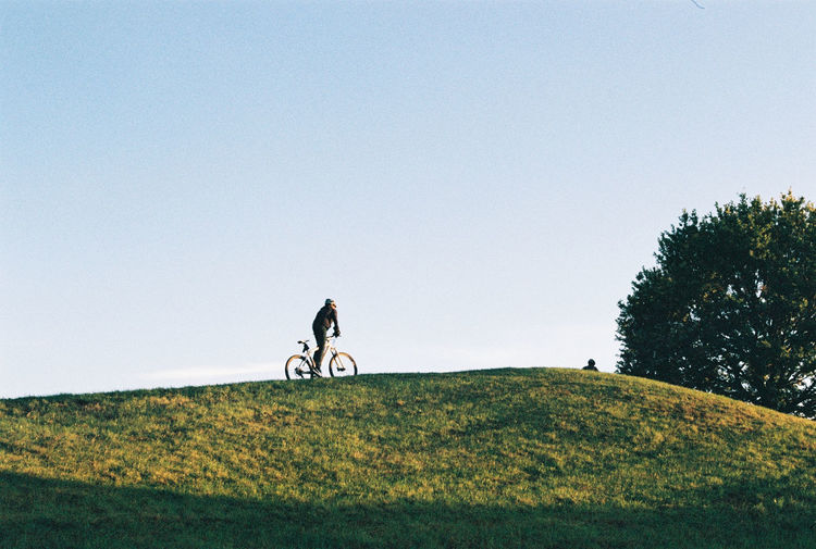 Man on bicycle against clear sky