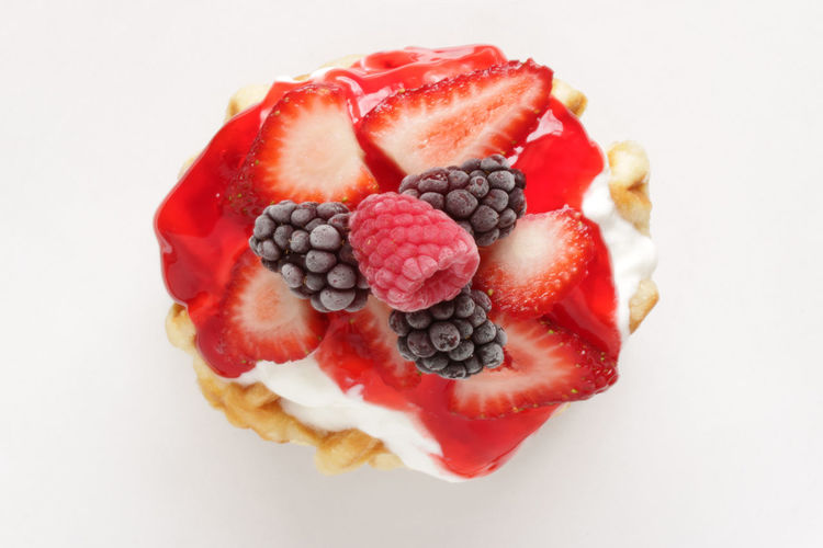 Close-up of strawberry cake against white background