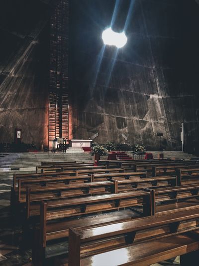 Empty benches in illuminated building