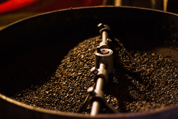 High angle view of roasted coffee beans in grinder