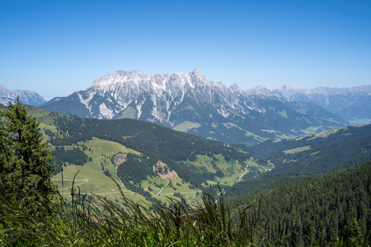 Scenic view of mountains against clear blue sky