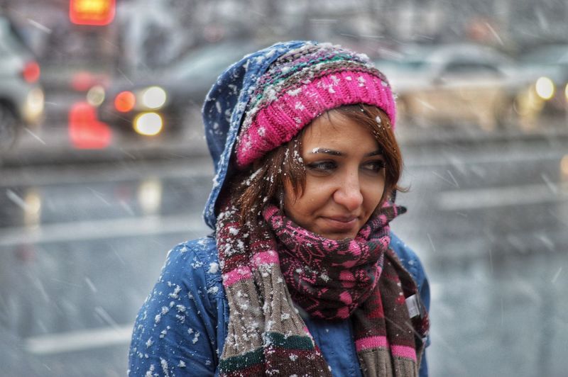 Smiling beautiful woman wearing warm clothing during winter