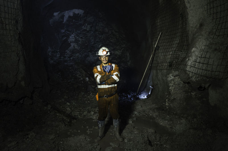 Portrait of worker standing at construction site