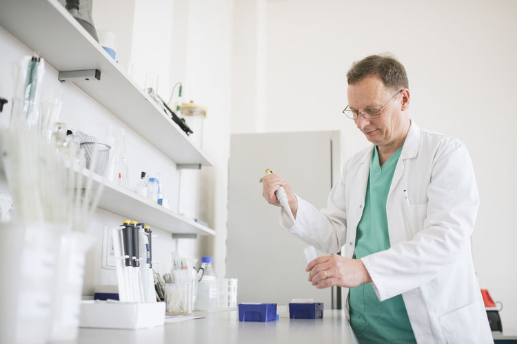 Researcher in white coat working in lab