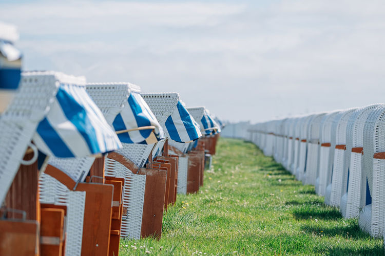 Rows of beach chairs on meadow