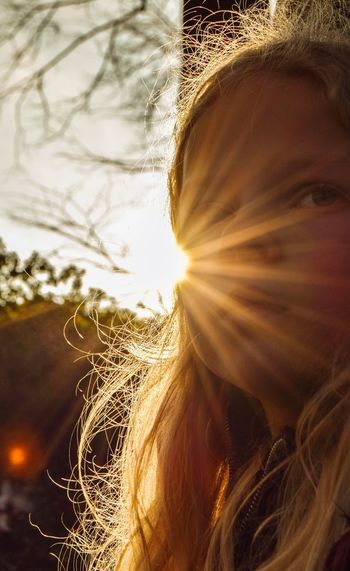 Close-up portrait of girl with sunbeam