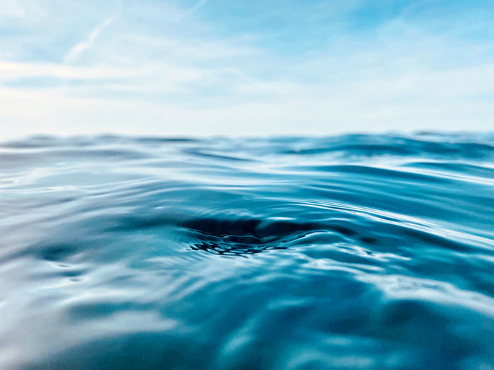 Close-up of rippled water in sea against sky