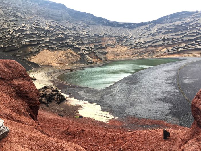 Scenic view of lake in volcanic landscape