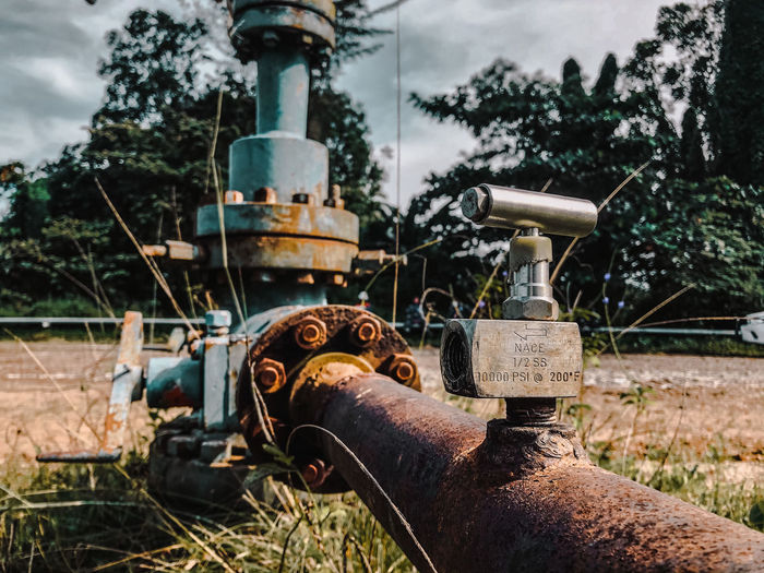 Rusty machine part on field