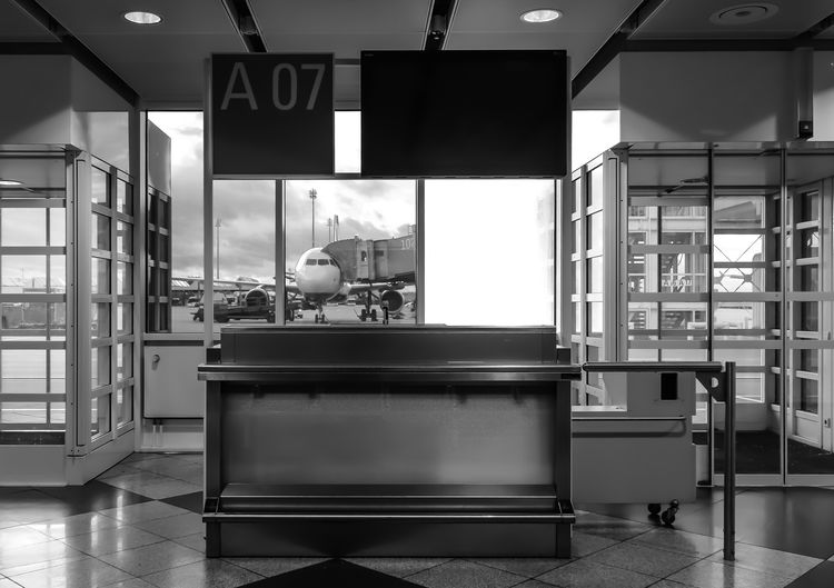 Airplane seen from closed gate at airport