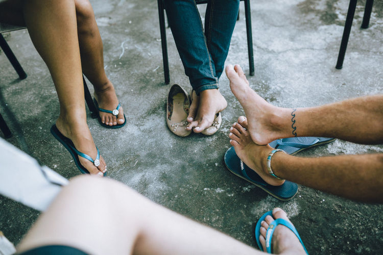 Low section of people sitting on floor