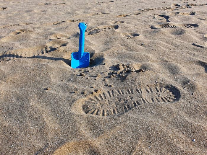 High angle view of footprints on sand