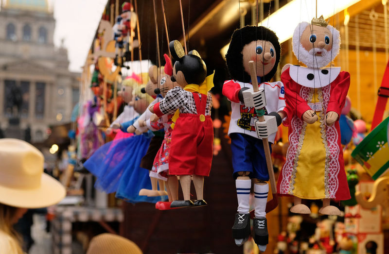 Traditional wooden puppet toys hang at a market stalls in prague, cz. marionette puppet toys.