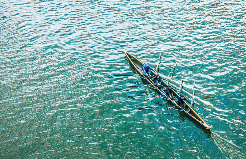High angle view of people rowing boat on sea