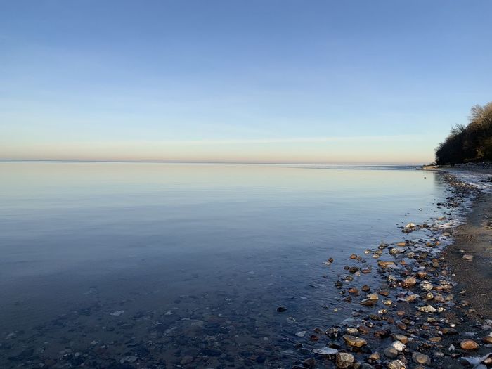 Scenic view of sea against clear sky during winter