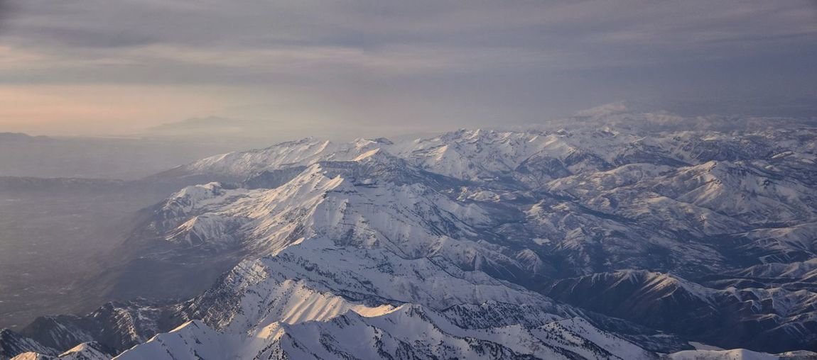 Wasatch front rocky mountain range aerial snow capped peaks winter urban salt lake city utah usa