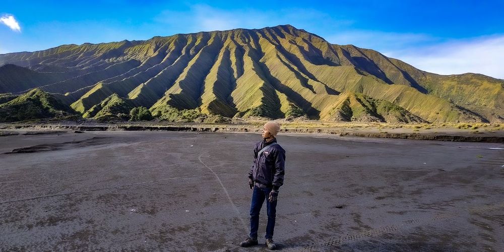 The man who stands in front of the batok mountain in the bromo