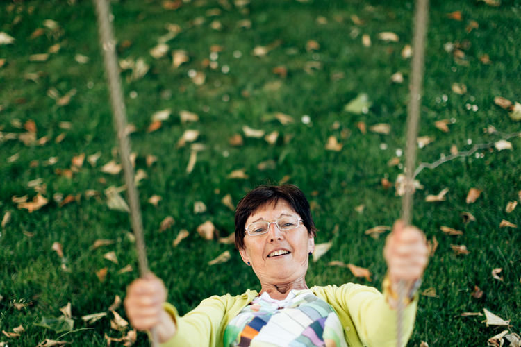 Top view of a healthy old lady on the swing - active and playful third age