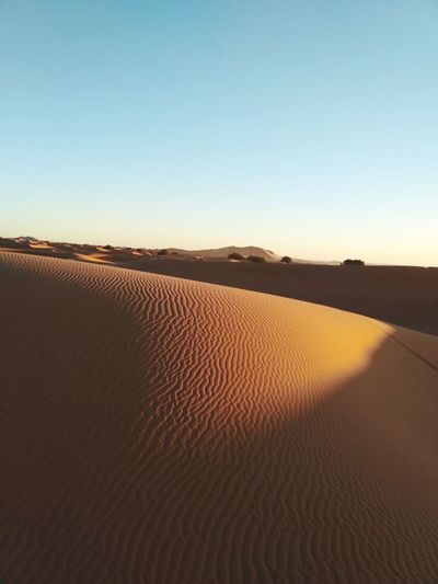 Scenic view of desert against clear sky