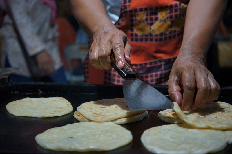 Midsection of man preparing food
