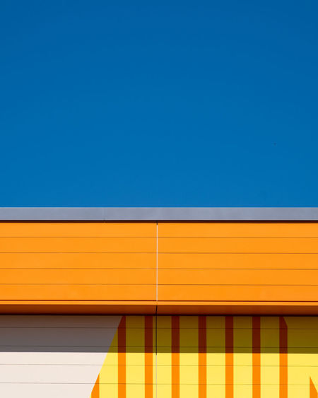 Low angle view of building against clear blue sky