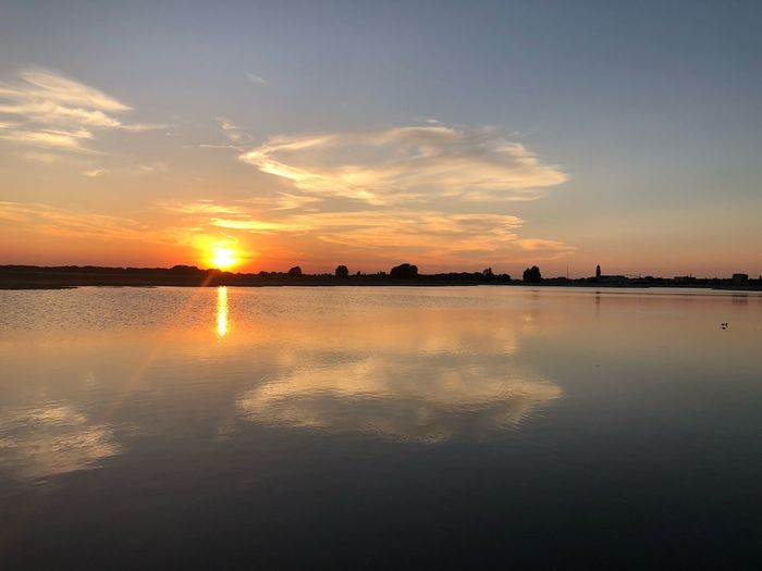 Scenic view of lake against sky during sunset