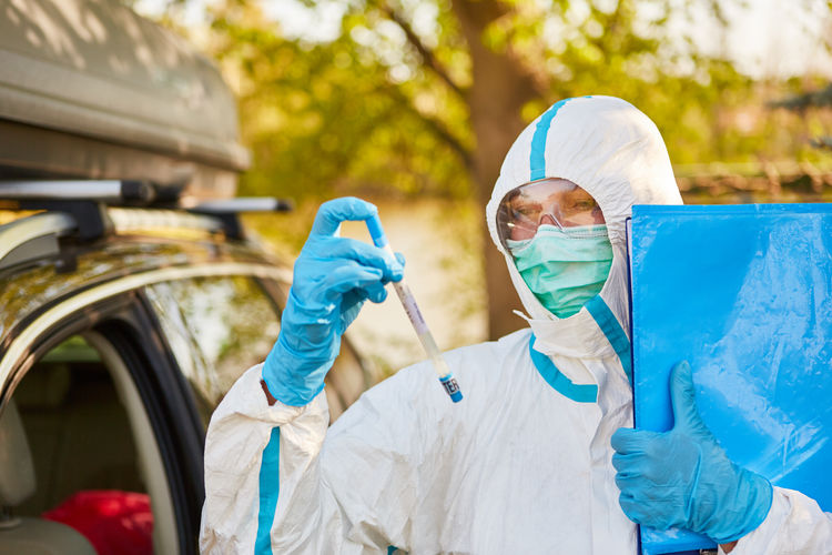 Medical professionals consider coronavirus rapid test as a throat smear in a drive-in test station