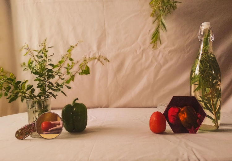 Reflection of fruits on table against wall