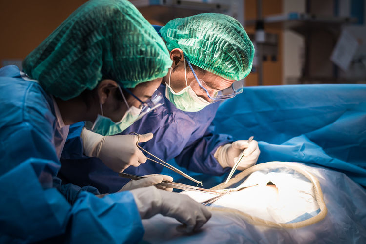 Surgeons operating patient at hospital