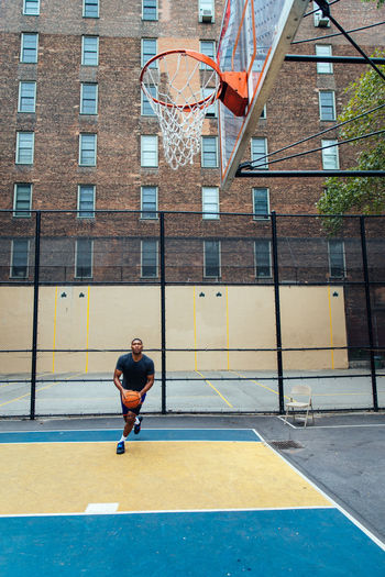 Young man playing basketball at court