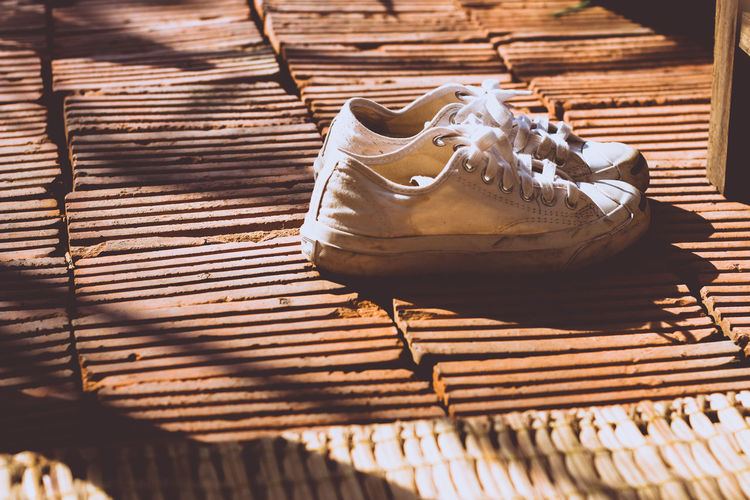 High angle view of shoes on bricks
