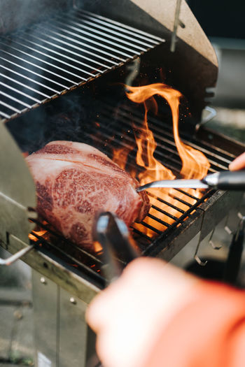 Steak surrounded by high flames on a  barbecue