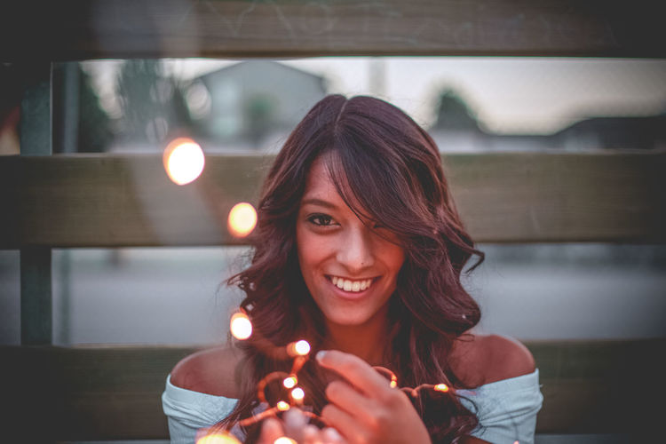 Portrait of young woman holding umbrella