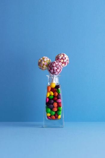 Multi colored candies against blue background