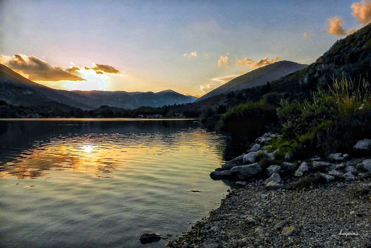 Scenic view of lake against sky during sunset