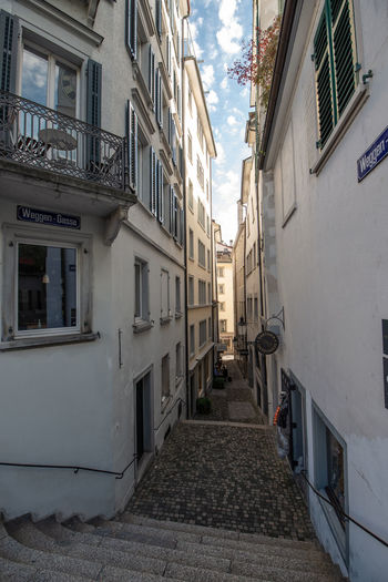 Empty alley amidst buildings in city
