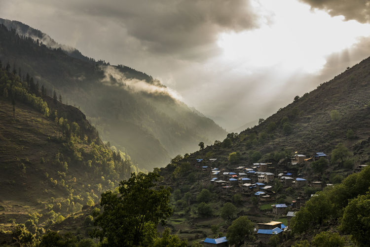 Landscape of green mountain valley and village at sunset in nepal