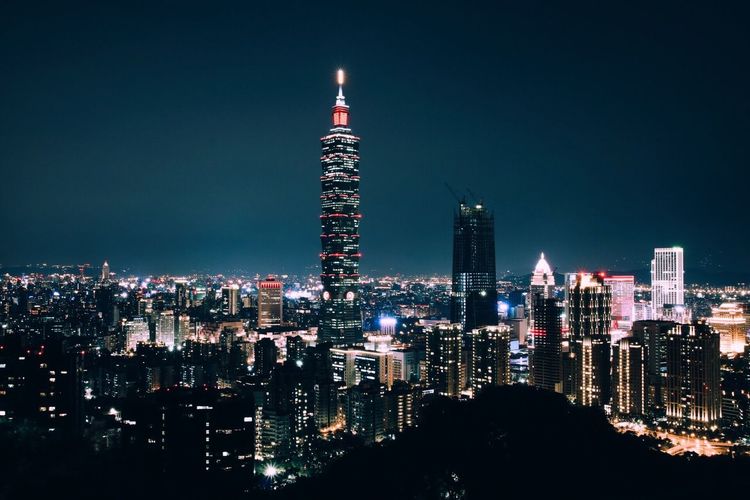 Illuminated taipei 101 against sky in city at night