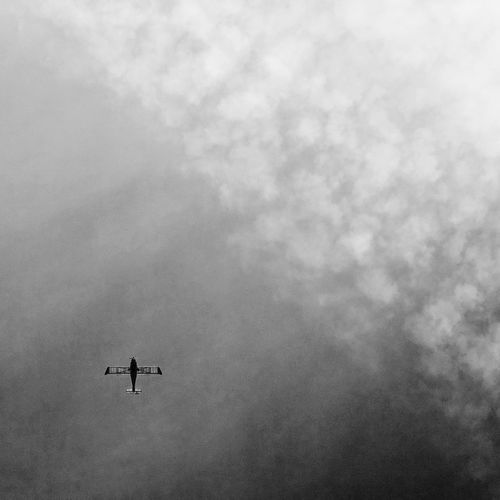 Low angle view of airplane flying in sky