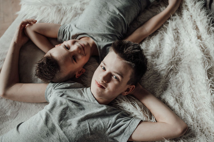 Portrait of young man lying on bed