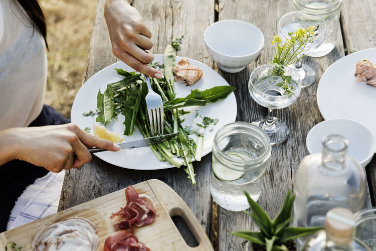 High angle view of woman having salad at table