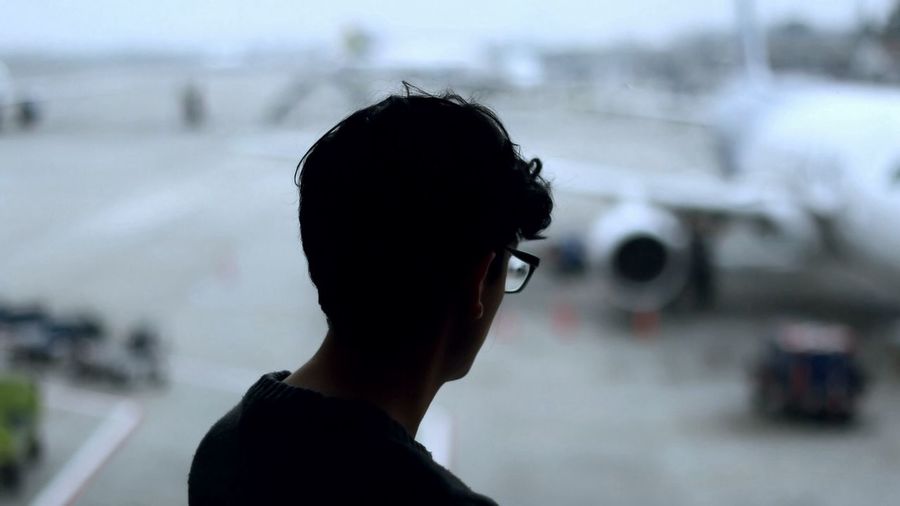 Man against blurred airplane