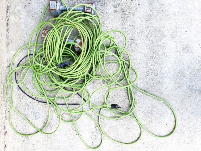 Electric trimmer cables on a concrete 