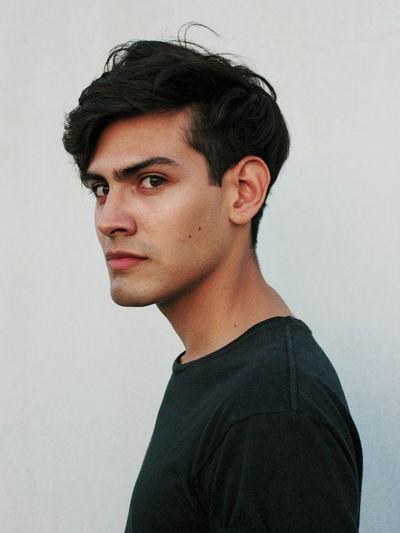 Portrait of young man against white background