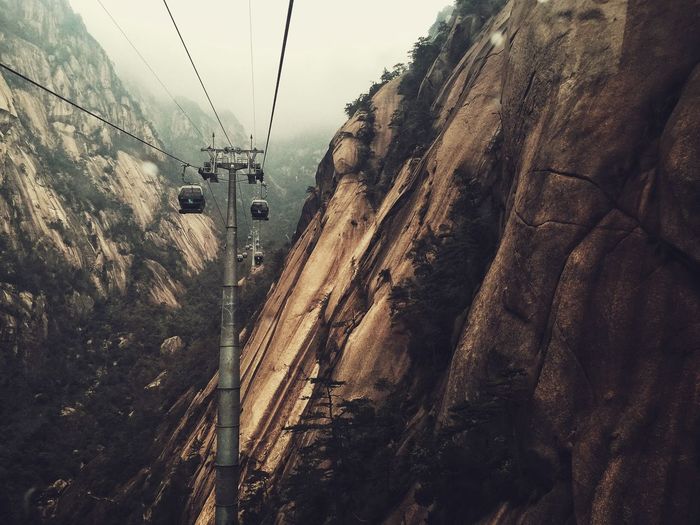 Overhead cable cars amidst mountains