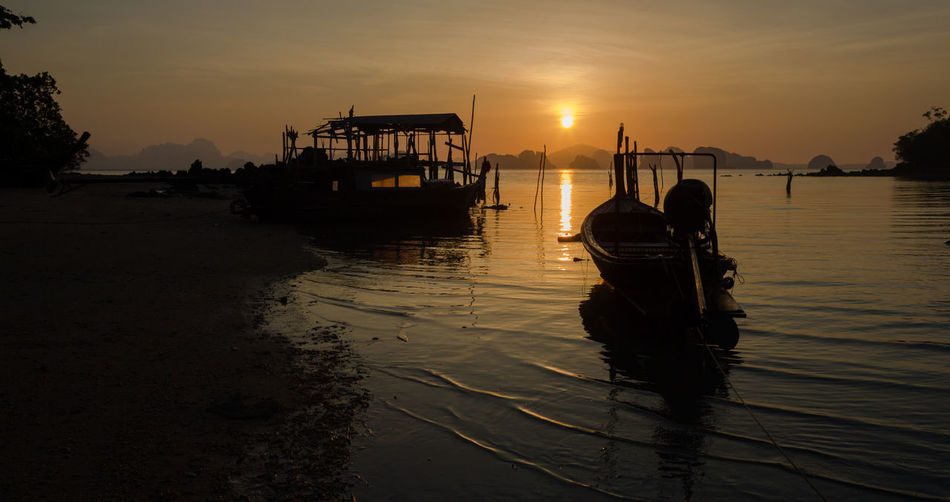 Silhouette boat on sea against sky during sunset